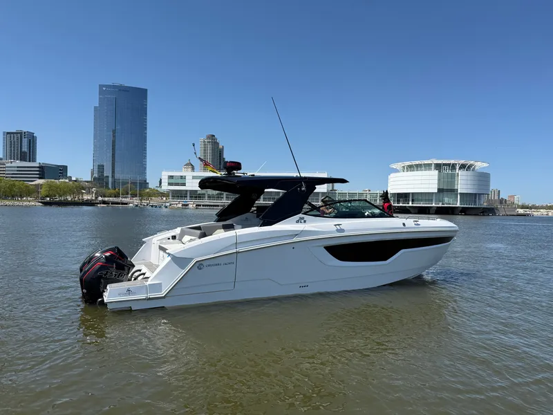 Slide: The Image of 2021 Cruisers Yachts 38 GLS on water with city buildings in background. - 3