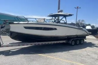 The Image of 2024 Navan S30 boat on a trailer in a parking lot under clear skies. - 1