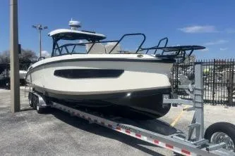 Slide: The Image of 2024 Navan S30 boat on trailer, parked outdoors under clear blue sky. - 3