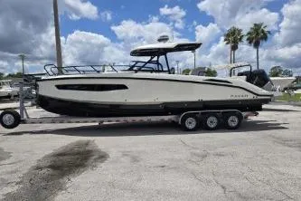 Slide: The Image of 2024 Navan S30 boat on trailer under cloudy sky with palm trees. - 4