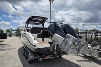 Slide: The Image of 2024 Navan S30 boat with dual outboard motors on a trailer under cloudy sky. - 5
