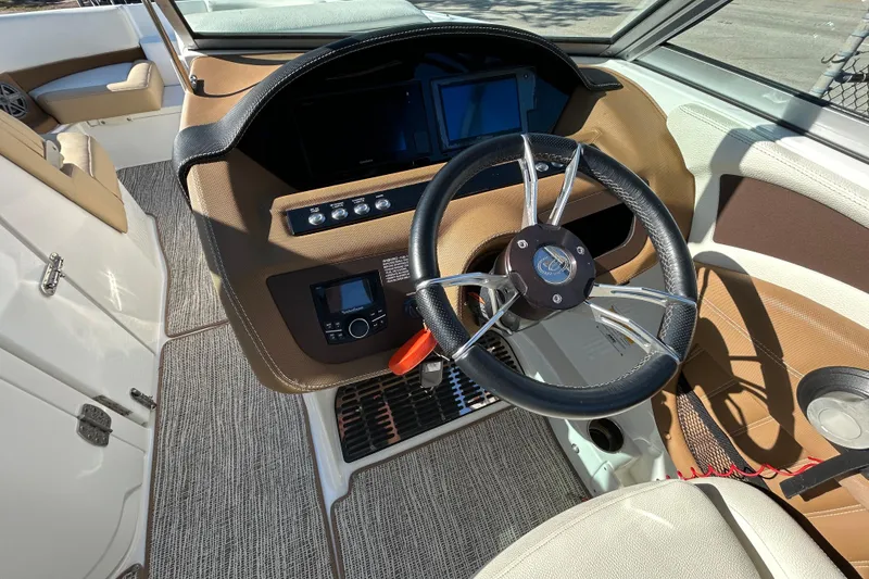 Slide: The Image of Interior view of 2018 Cobalt 25SC boat cockpit with steering wheel and controls. - 19