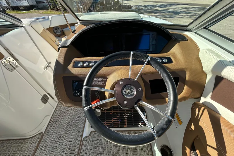 Slide: The Image of Steering wheel and dashboard of a 2018 Cobalt 25SC boat, featuring modern controls. - 20