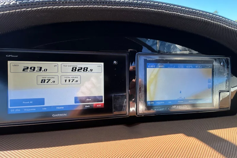 Slide: The Image of Dashboard of a 2018 Cobalt 25SC boat displaying trip data on Garmin screens. - 26
