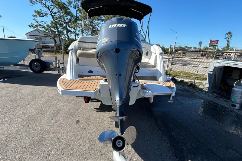 Slide: The Image of 2018 Cobalt 25SC boat with outboard motor, parked on a sunny day. - 6