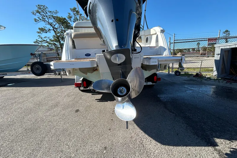 Slide: The Image of 2018 Cobalt 25SC boat with outboard motor and propeller, parked on a sunny day. - 7
