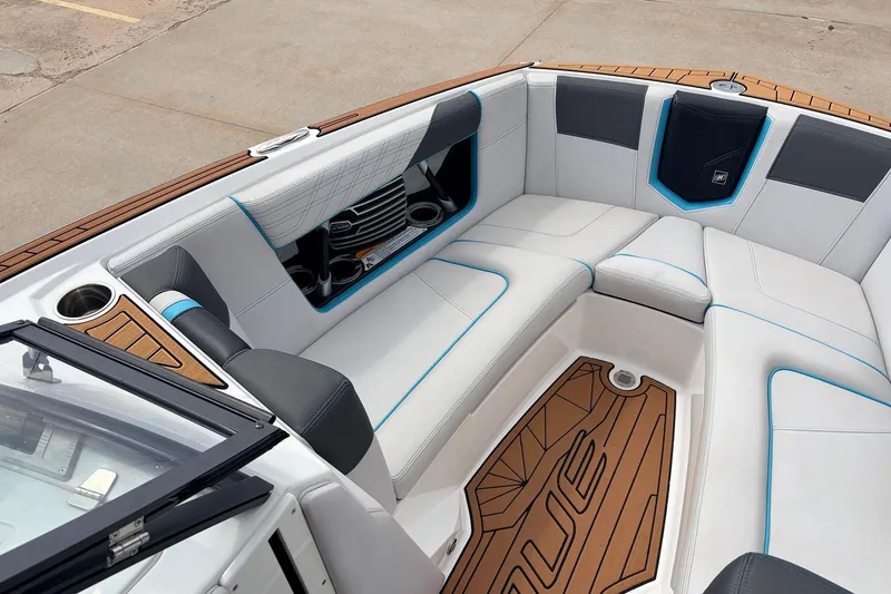 Slide: The Image of 2017 Nautique Super Air Nautique G23 boat interior with white seating and wood accents. - 11