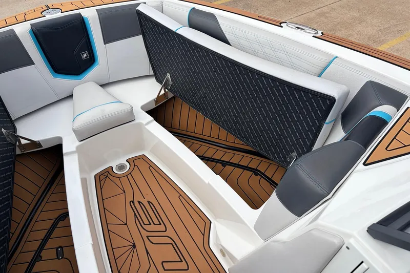 Slide: The Image of 2017 Nautique Super Air Nautique G23 boat interior with cushioned seating and teak flooring. - 16