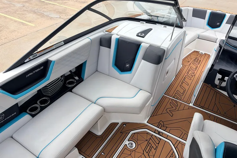 Slide: The Image of 2017 Nautique Super Air Nautique G23 interior with white seating and brown flooring. - 18