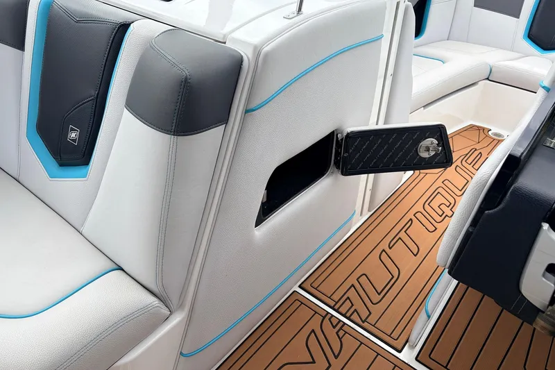 Slide: The Image of 2017 Nautique Super Air Nautique G23 interior with sleek seating and branded flooring. - 20