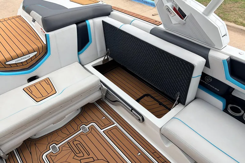 Slide: The Image of 2017 Nautique Super Air Nautique G23 interior with open storage compartment and teak flooring. - 24