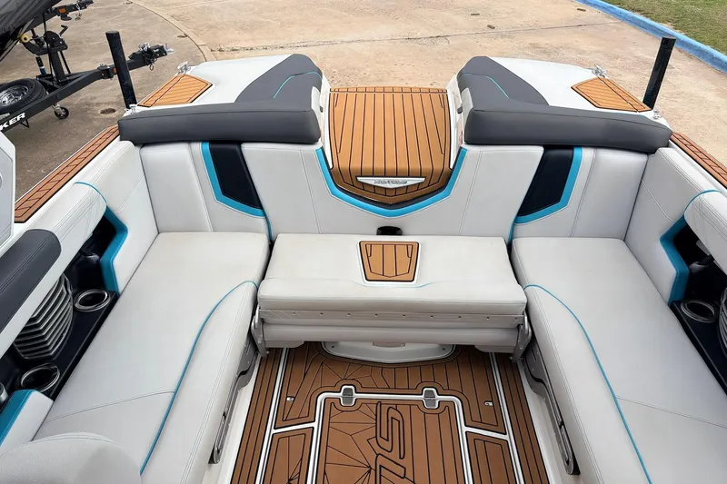 Slide: The Image of 2017 Nautique Super Air Nautique G23 interior with white and blue seating, teak flooring. - 25