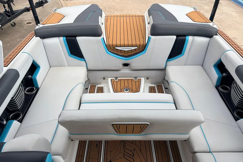 Slide: The Image of 2017 Nautique Super Air Nautique G23 interior with white and blue seating, teak flooring. - 27
