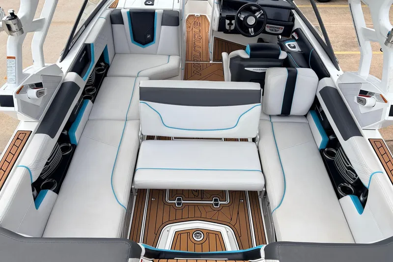 Slide: The Image of 2017 Nautique Super Air Nautique G23 interior with white and blue seating, teak flooring. - 28