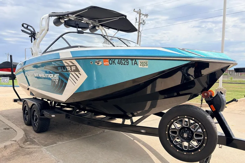 Slide: The Image of 2017 Nautique Super Air Nautique G23 boat on trailer, blue and white design. - 3