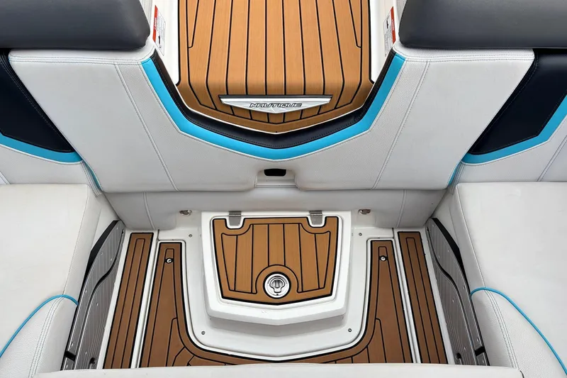 Slide: The Image of 2017 Nautique Super Air Nautique G23 interior with teak flooring and white seating. - 30