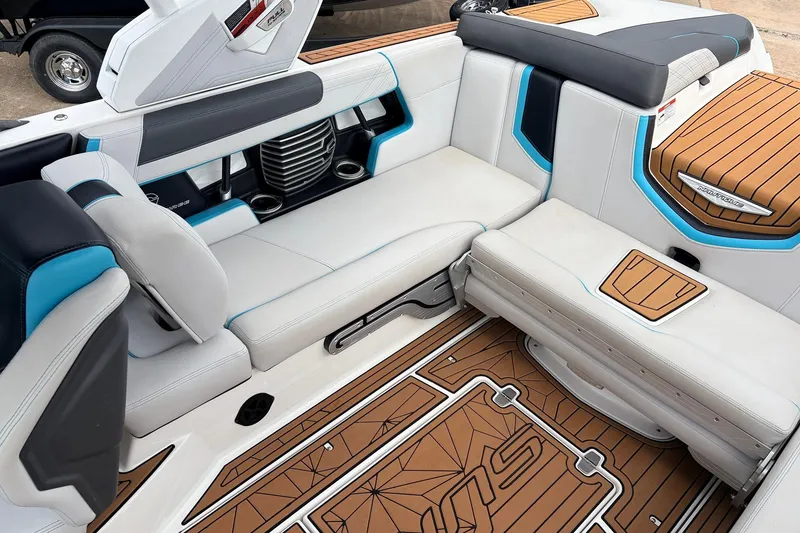 Slide: The Image of 2017 Nautique Super Air Nautique G23 interior with white and blue seating, teak flooring. - 32