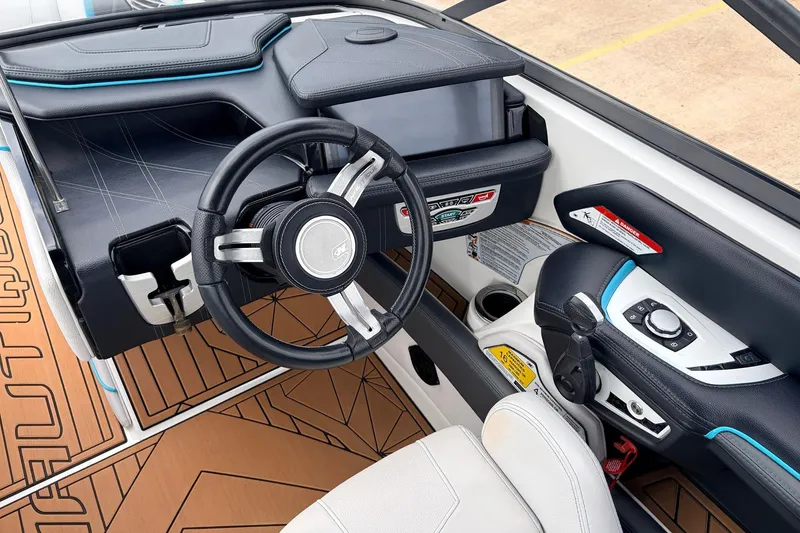 Slide: The Image of 2017 Nautique Super Air Nautique G23 cockpit with modern steering and control panel. - 38