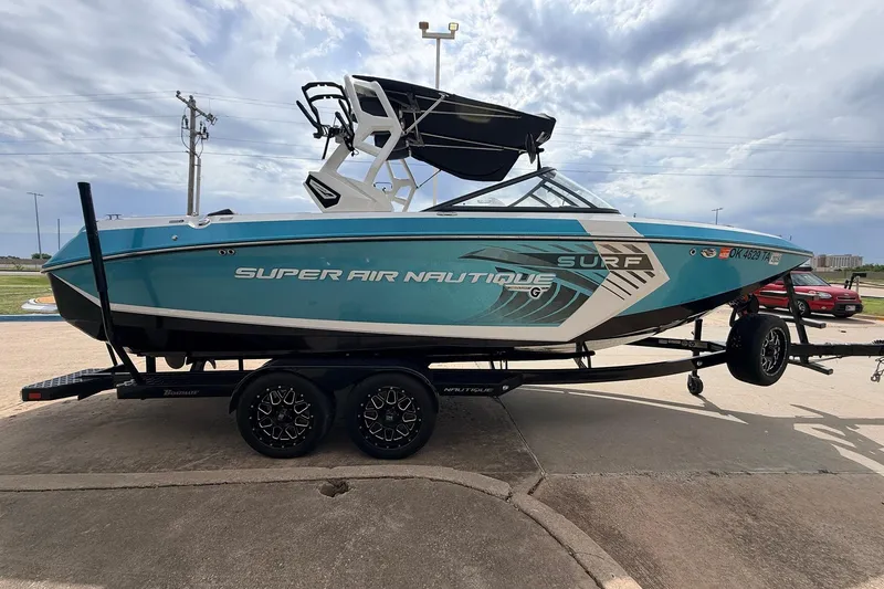 Slide: The Image of 2017 Nautique Super Air Nautique G23 boat on trailer, blue and white design. - 4