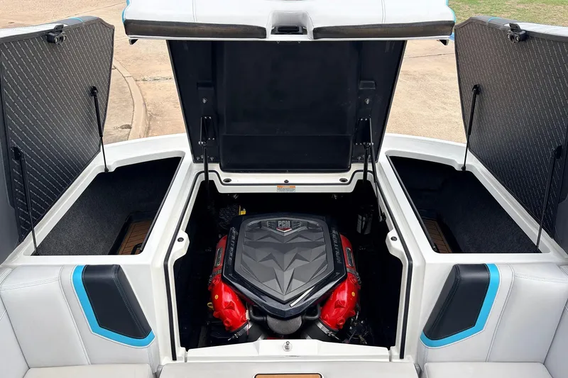 Slide: The Image of 2017 Nautique Super Air Nautique G23 engine compartment with open storage hatches. - 42