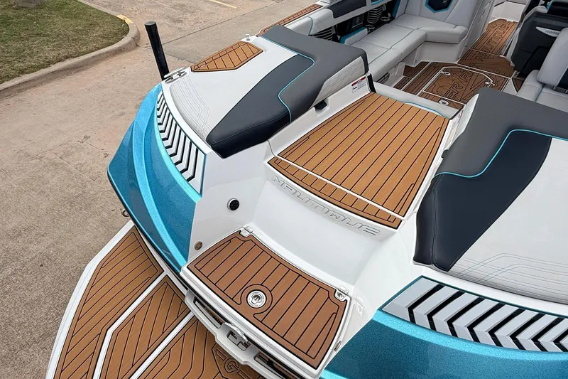 Slide: The Image of 2017 Nautique Super Air Nautique G23 boat interior with teak flooring and cushioned seating. - 46