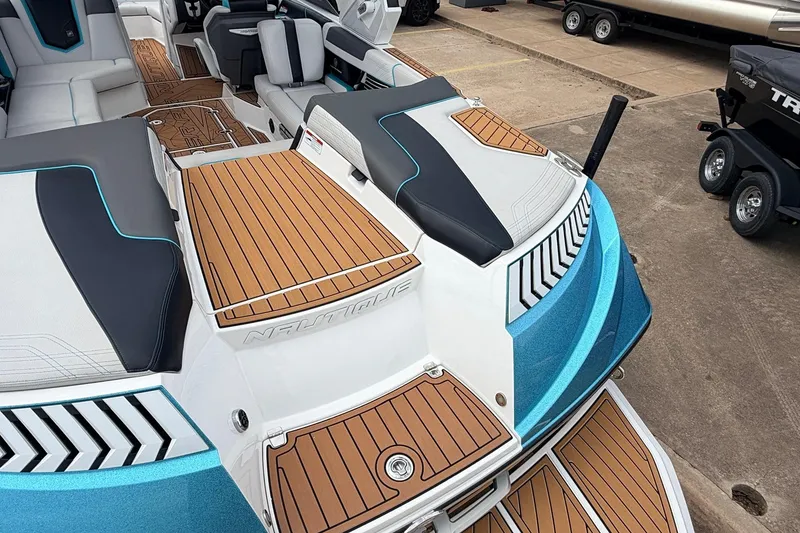 Slide: The Image of 2017 Nautique Super Air Nautique G23 boat interior with teak flooring and cushioned seating. - 47