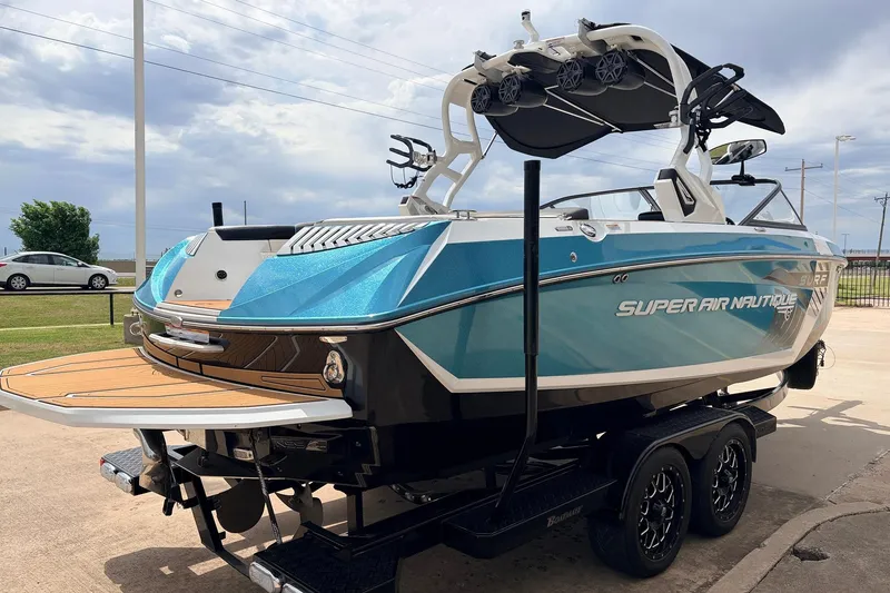 Slide: The Image of 2017 Nautique Super Air Nautique G23 boat on trailer, featuring sleek blue design. - 5