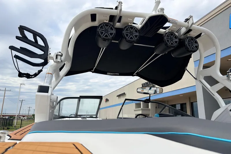 Slide: The Image of 2017 Nautique Super Air Nautique G23 boat with wakeboard tower and speakers, docked outdoors. - 51