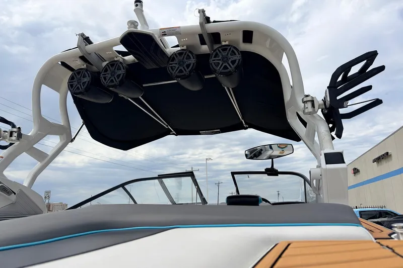 Slide: The Image of 2017 Nautique Super Air Nautique G23 boat with wakeboard tower and speakers under cloudy sky. - 52