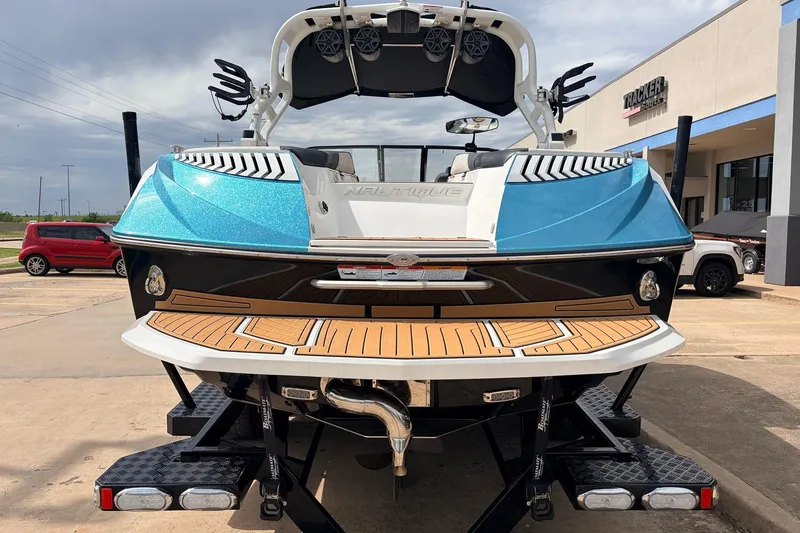Slide: The Image of 2017 Nautique Super Air Nautique G23 boat on trailer, rear view, blue and white design. - 6