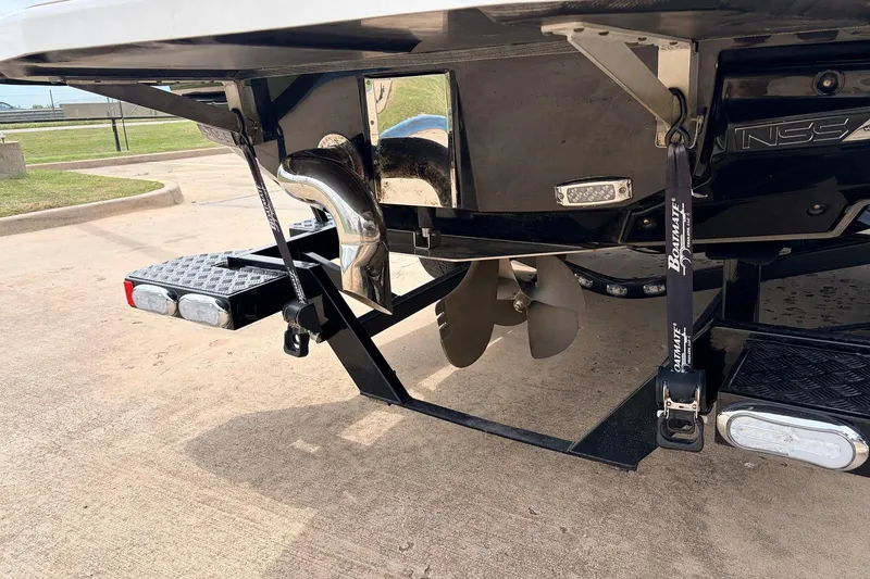 Slide: The Image of 2017 Nautique Super Air Nautique G23 boat trailer with propeller and exhaust detail. - 8