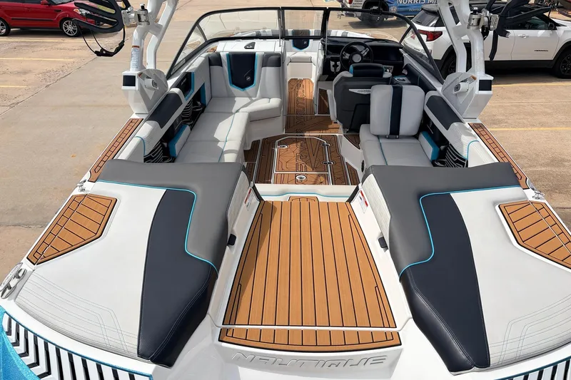 Slide: The Image of 2017 Nautique Super Air Nautique G23 boat interior with sleek seating and teak flooring. - 9