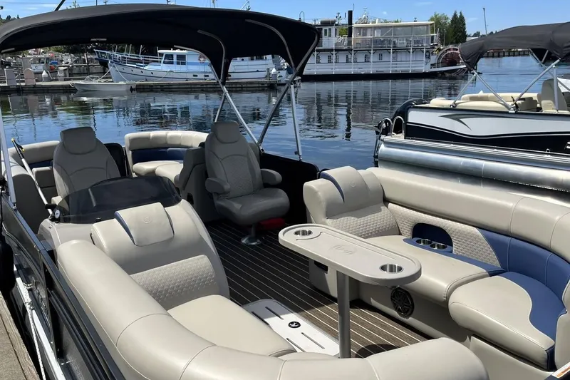 Slide: The Image of 2022 Premier 230 Sunsation RF - CL pontoon boat with luxurious seating at a marina. - 2
