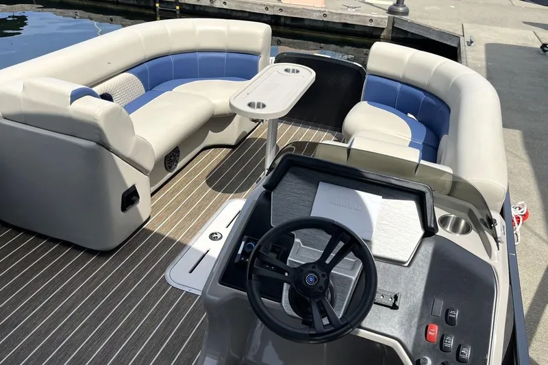 Slide: The Image of 2022 Premier 230 Sunsation RF - CL pontoon boat interior with seating and steering console. - 3