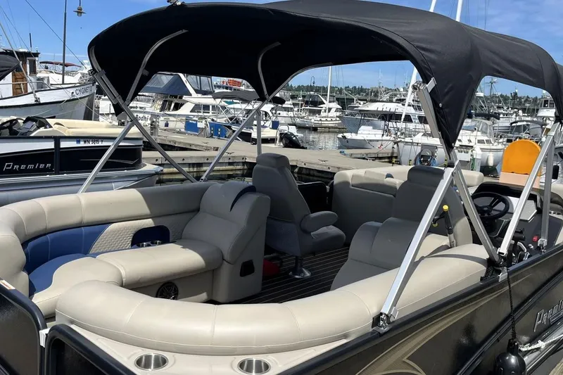 Slide: The Image of 2022 Premier 230 Sunsation RF - CL pontoon boat with canopy, docked at marina. - 4