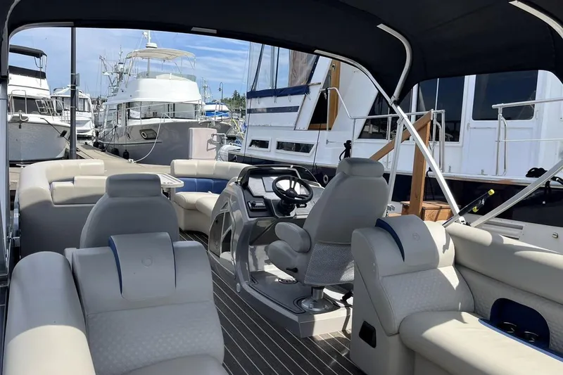 Slide: The Image of Interior view of 2022 Premier 230 Sunsation RF - CL pontoon boat at marina. - 5
