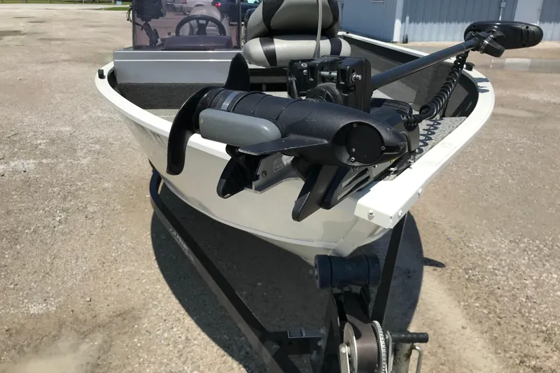 Slide: The Image of 2014 Lowe Fishing Machine 165SC Pro boat with trolling motor on trailer. - 11