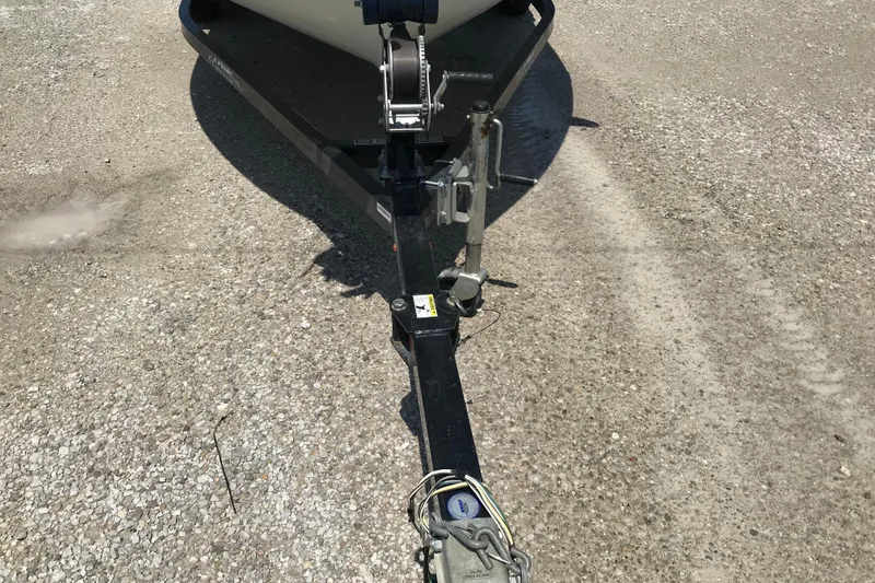 Slide: The Image of 2014 Lowe Fishing Machine 165SC Pro trailer hitch on gravel surface. - 13
