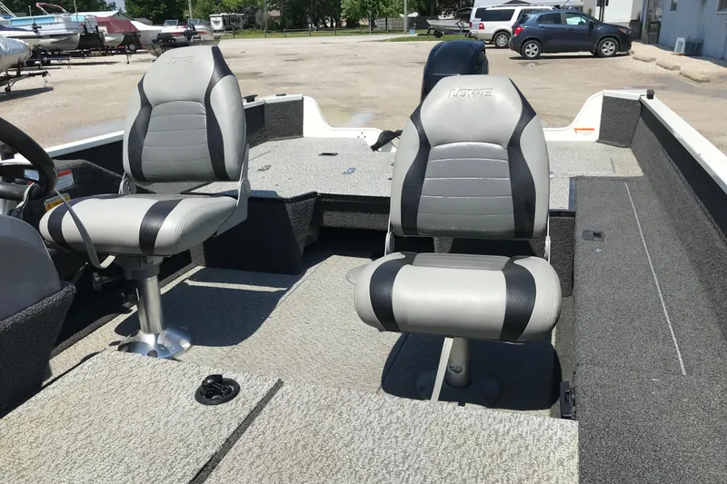 Slide: The Image of 2014 Lowe Fishing Machine 165SC Pro interior with two cushioned seats and spacious deck. - 16