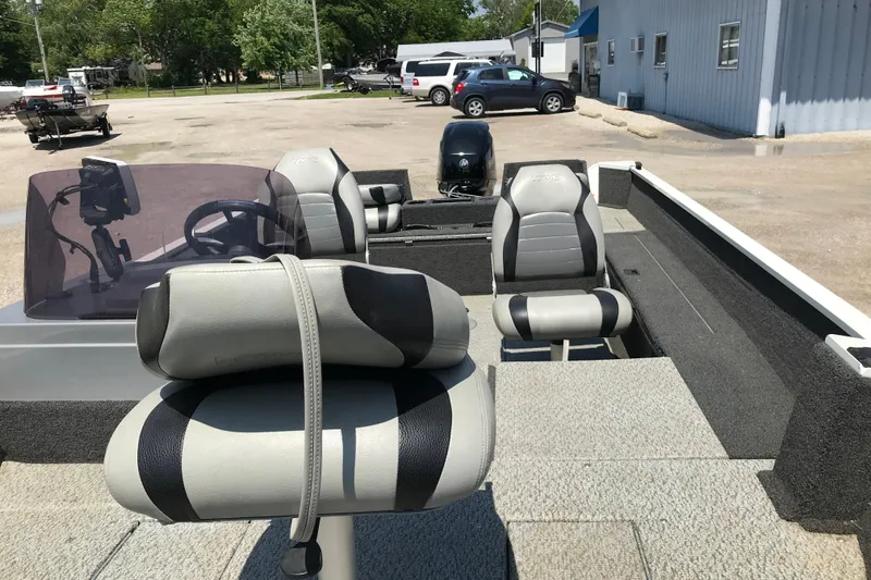 Slide: The Image of 2014 Lowe Fishing Machine 165SC Pro boat interior with seating and steering console. - 18