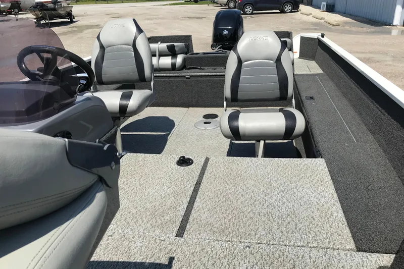 Slide: The Image of 2014 Lowe Fishing Machine 165SC Pro interior with gray seating and steering console. - 19