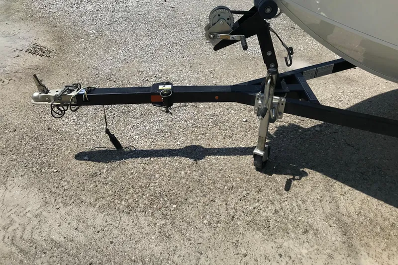 Slide: The Image of Trailer hitch and wheel of a 2014 Lowe Fishing Machine 165SC Pro on gravel. - 20