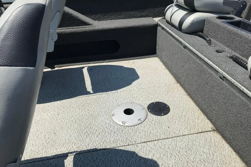Slide: The Image of Interior of a 2014 Lowe Fishing Machine 165SC Pro boat, featuring seating and deck details. - 24