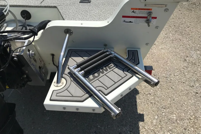 Slide: The Image of 2014 Lowe Fishing Machine 165SC Pro with folded swim ladder on deck. - 5