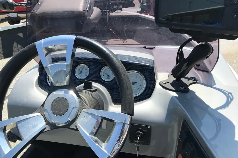 Slide: The Image of Steering console of 2014 Lowe Fishing Machine 165SC Pro with gauges and navigation system. - 6