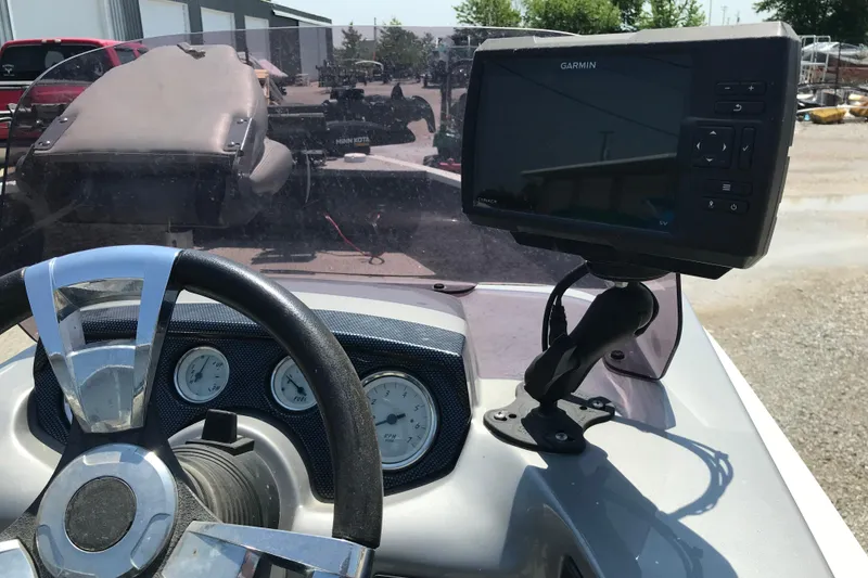 Slide: The Image of 2014 Lowe Fishing Machine 165SC Pro dashboard with Garmin fishfinder and steering wheel. - 7