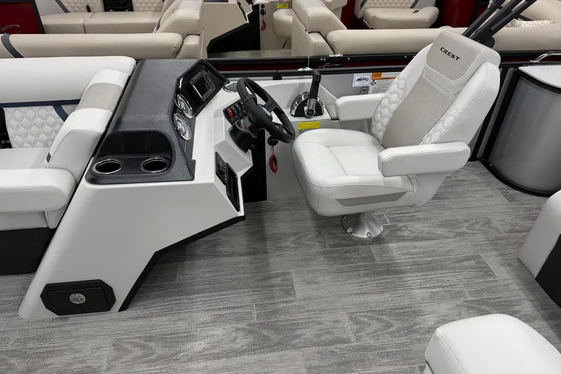 Slide: The Image of 2026 Crest Conquest 210 SLS boat interior with modern helm and luxurious seating. - 5