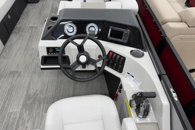 Slide: The Image of Steering console of 2026 Crest Conquest 210 SLS boat with modern controls and gauges. - 6