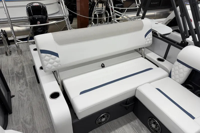 Slide: The Image of 2026 Crest Conquest 210 SLS boat interior with white cushioned seating and cup holders. - 8