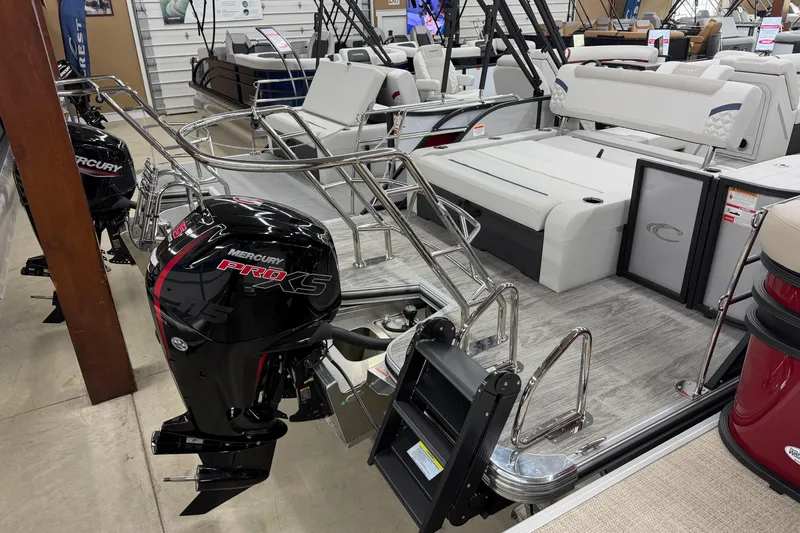 Slide: The Image of 2026 Crest Conquest 210 SLS pontoon boat with Mercury Pro XS engine in showroom. - 9